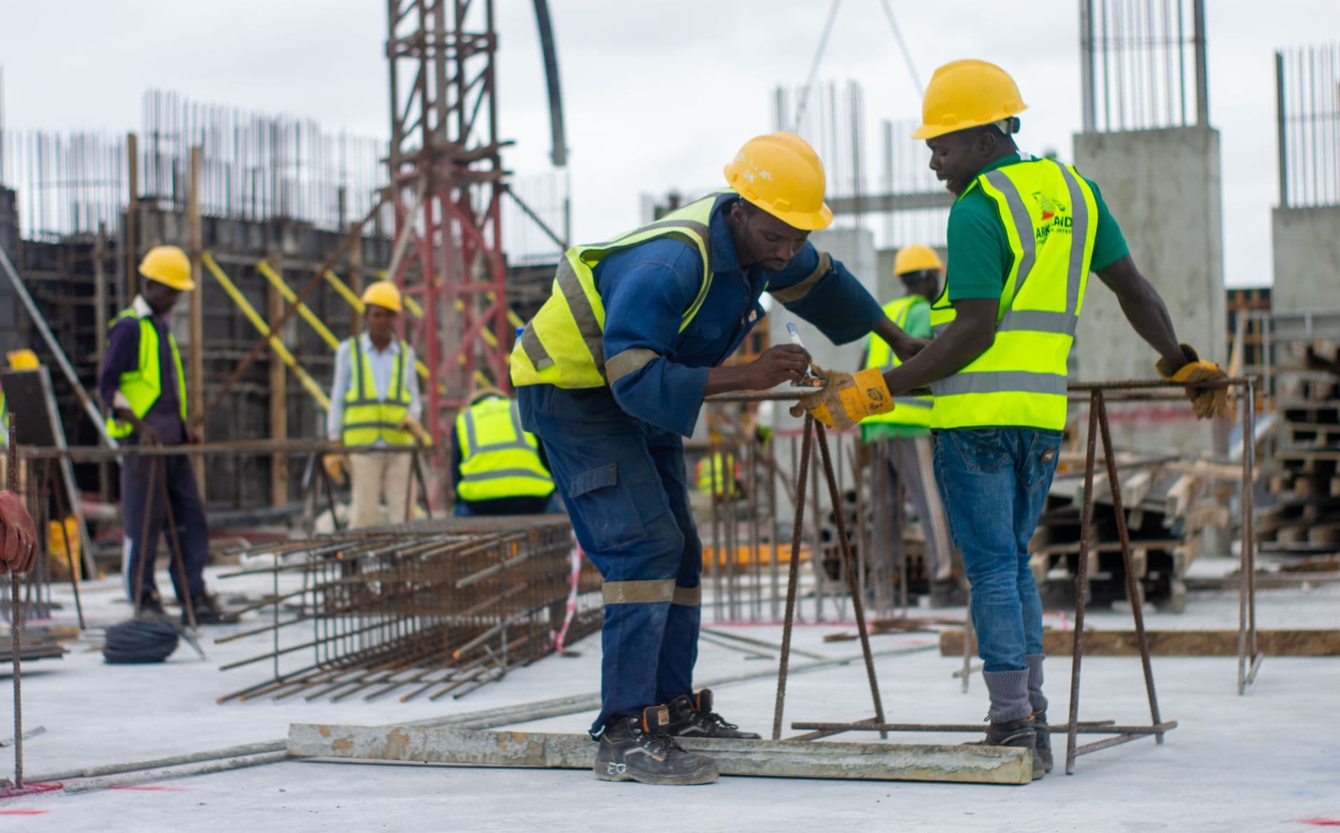 Refinery and construction workers in high visibility uniforms