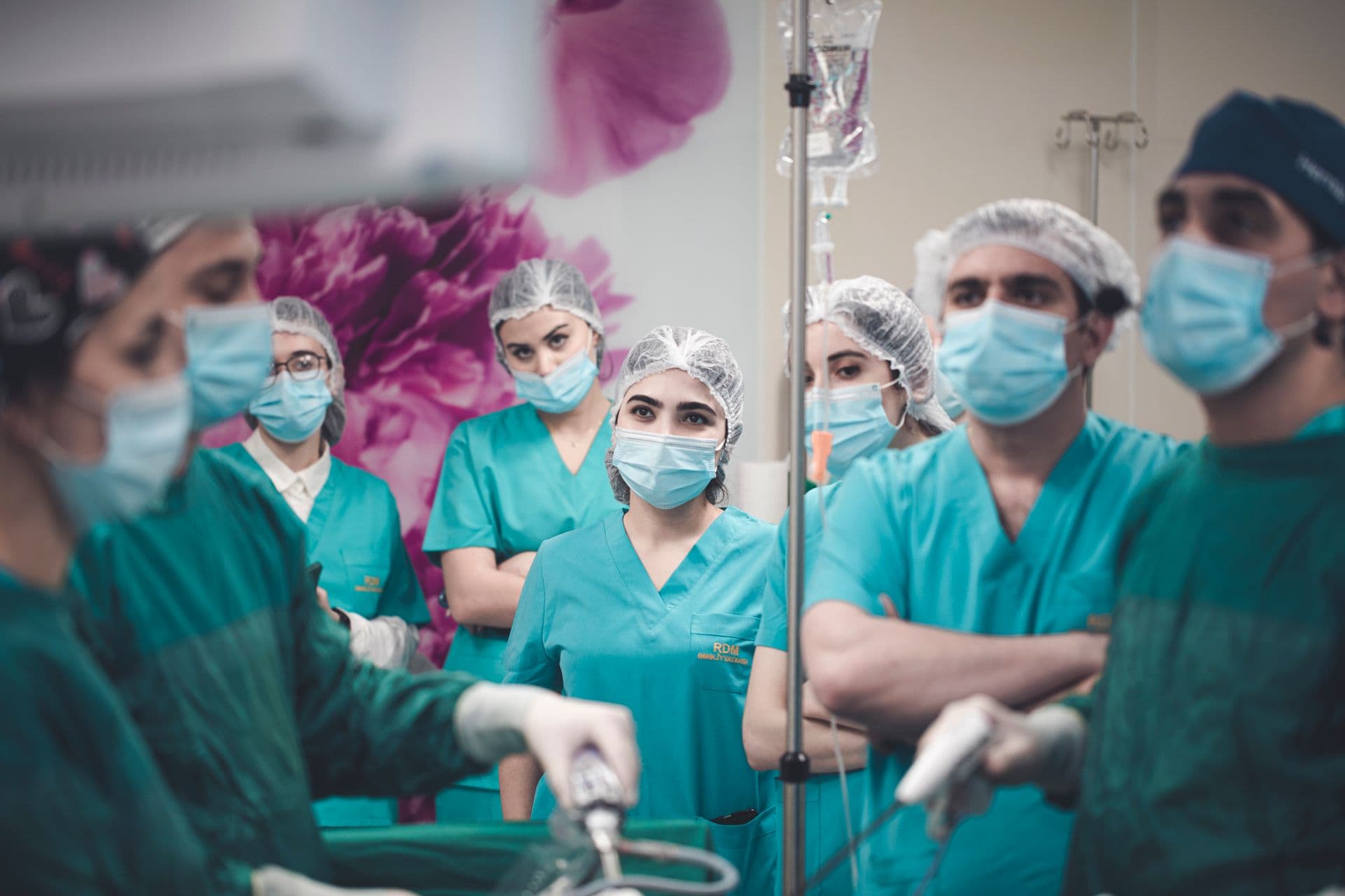 Surgical team in green theatre gowns during a procedure